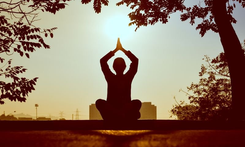 Person seated in serene outdoor meditation pose